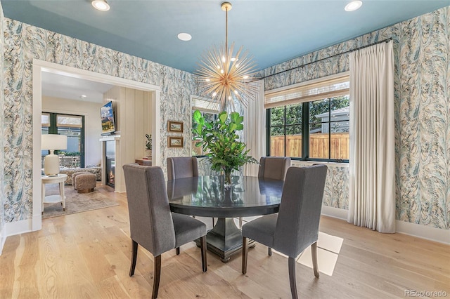 dining area featuring an inviting chandelier and light hardwood / wood-style floors