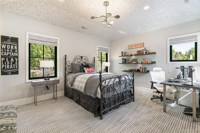 bedroom featuring an inviting chandelier, a textured ceiling, and multiple windows