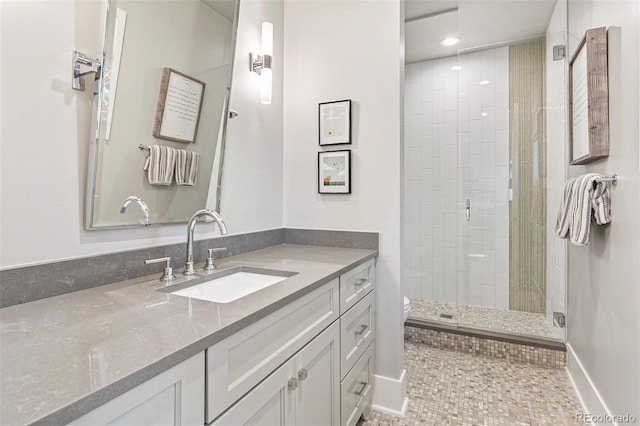 bathroom with tile patterned flooring, walk in shower, vanity, and toilet