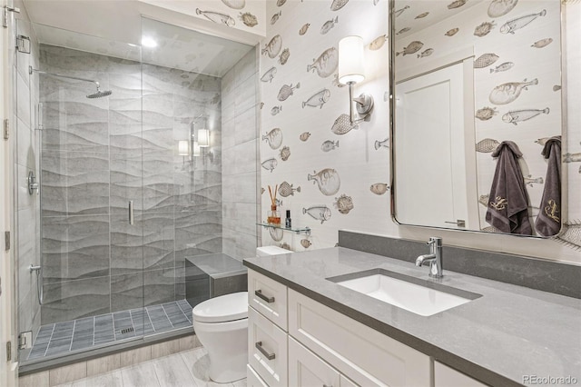 bathroom with walk in shower, wood-type flooring, vanity, and toilet