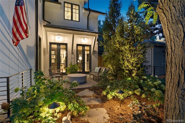 property entrance featuring french doors and a patio area