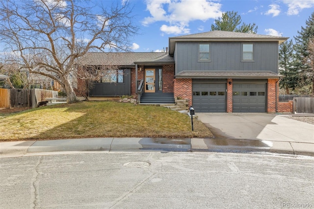 tri-level home with a garage and a front lawn