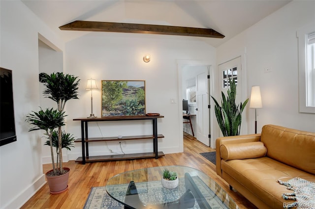 living room featuring light wood-type flooring and lofted ceiling with beams