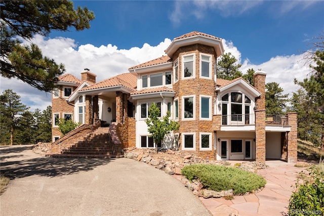 mediterranean / spanish home with a balcony