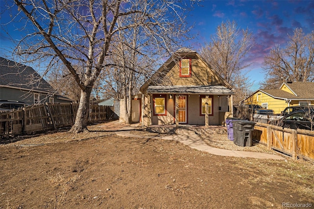 rear view of property with fence and stucco siding