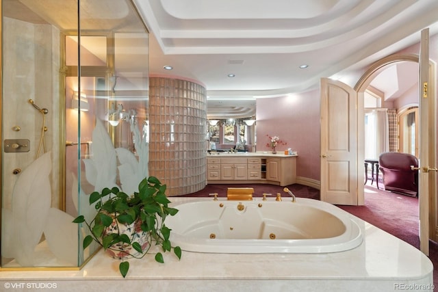 bathroom featuring vanity, a tray ceiling, and independent shower and bath