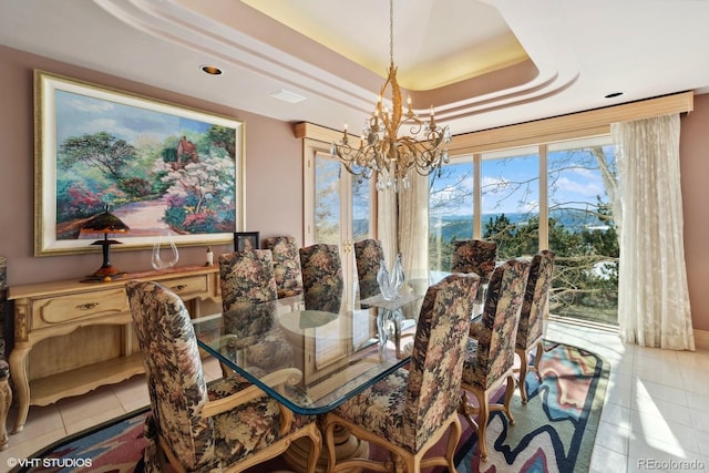 dining room featuring a raised ceiling, light tile patterned floors, and an inviting chandelier