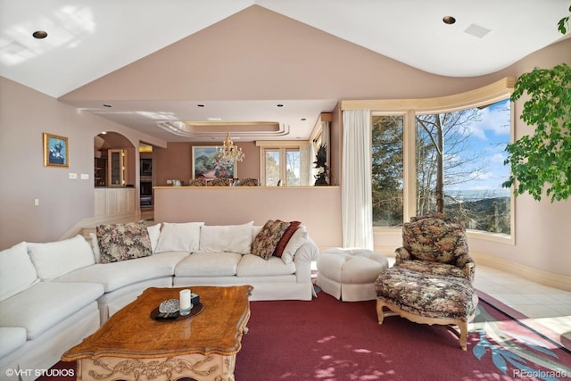 living room featuring plenty of natural light and lofted ceiling