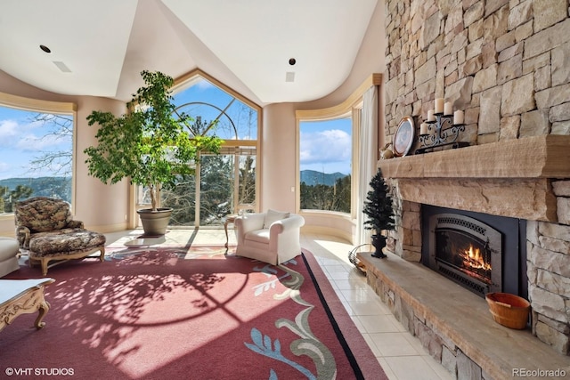 interior space with a mountain view, lofted ceiling, and a fireplace