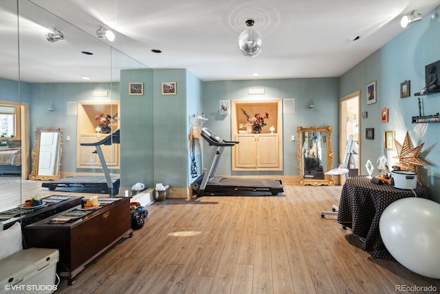 exercise area featuring hardwood / wood-style flooring