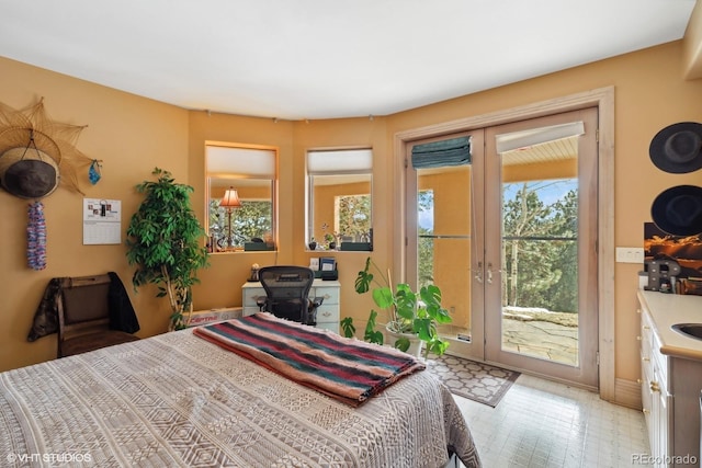 bedroom featuring access to exterior and multiple windows