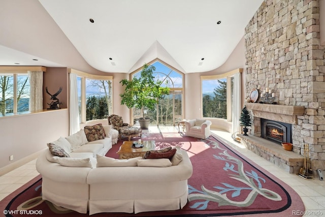 tiled living room with high vaulted ceiling and a stone fireplace