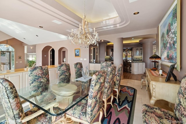 dining space with light tile patterned flooring and an inviting chandelier