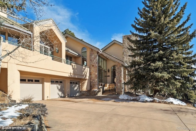 view of front facade with a balcony and a garage