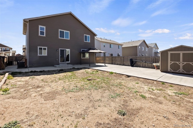6154 Fiddle Way, Colorado Springs, CO 80925 - back of property with a patio, a gazebo, a storage shed, and a fenced backyard