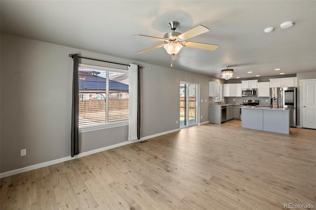 6154 Fiddle Way, Colorado Springs, CO 80925 - unfurnished living room featuring a ceiling fan, recessed lighting, light wood-style floors, and a chandelier