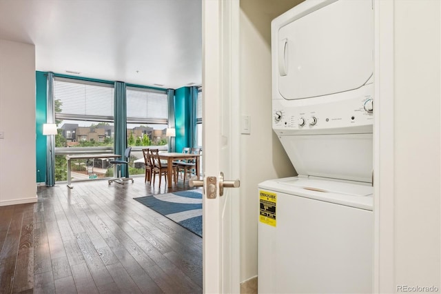 2958 Syracuse St Unit 317, Denver, CO 80238 - laundry area with stacked washing machine and dryer, dark wood-style flooring, and baseboards
