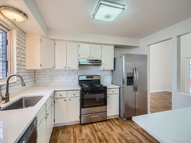 kitchen featuring sink, white cabinetry, stainless steel fridge with ice dispenser, gas range oven, and light hardwood / wood-style floors