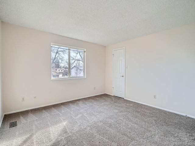 empty room featuring carpet floors and a textured ceiling