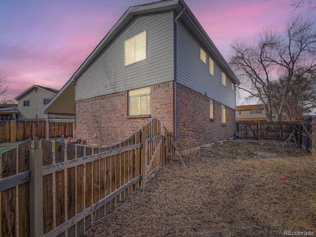 view of back house at dusk