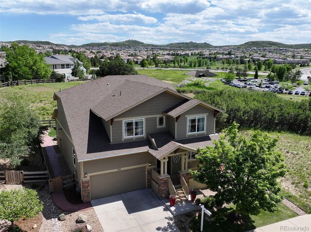 2815 Dreamcatcher Loop, Castle Rock, CO 80109 - view of front of property with a mountain view, stone siding, driveway, and a garage