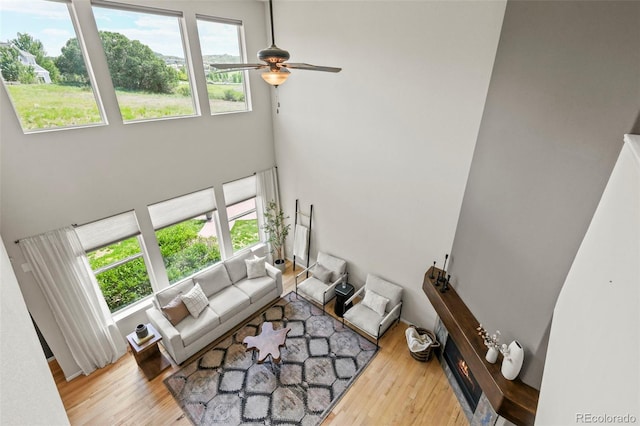 2815 Dreamcatcher Loop, Castle Rock, CO 80109 - living area featuring healthy amount of natural light, ceiling fan, wood finished floors, and a towering ceiling