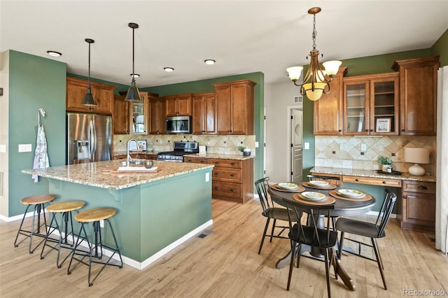 2815 Dreamcatcher Loop, Castle Rock, CO 80109 - kitchen with appliances with stainless steel finishes, a chandelier, and light wood-type flooring
