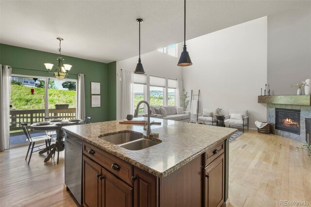 2815 Dreamcatcher Loop, Castle Rock, CO 80109 - kitchen with stainless steel dishwasher, open floor plan, light wood-style flooring, and a chandelier