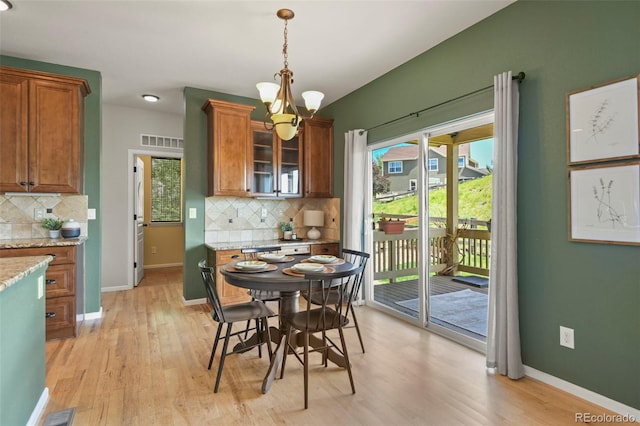2815 Dreamcatcher Loop, Castle Rock, CO 80109 - dining room with a chandelier, light wood-style floors, and healthy amount of natural light