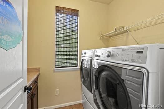 2815 Dreamcatcher Loop, Castle Rock, CO 80109 - washroom featuring washer and clothes dryer and cabinet space