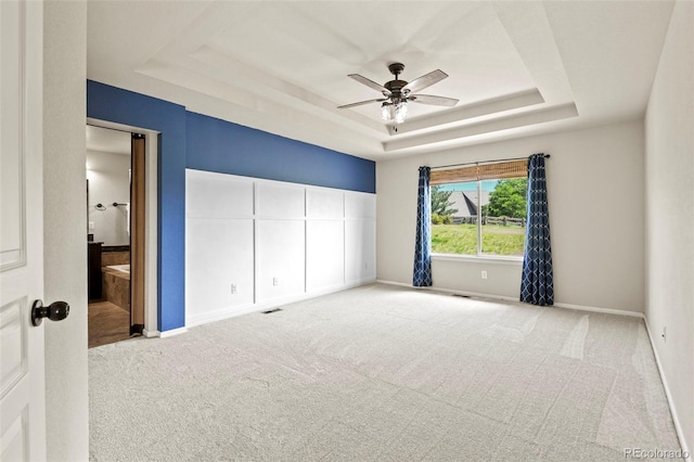 2815 Dreamcatcher Loop, Castle Rock, CO 80109 - unfurnished bedroom with a raised ceiling, carpet floors, connected bathroom, and ceiling fan