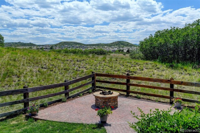 2815 Dreamcatcher Loop, Castle Rock, CO 80109 - view of patio featuring an outdoor fire pit and a mountain view