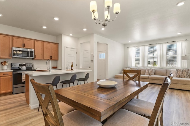 23920 E 34th Ave, Aurora, CO 80019 - dining space featuring light wood-style flooring, recessed lighting, and a chandelier