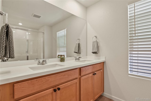 23920 E 34th Ave, Aurora, CO 80019 - bathroom with a shower stall, double vanity, and baseboards