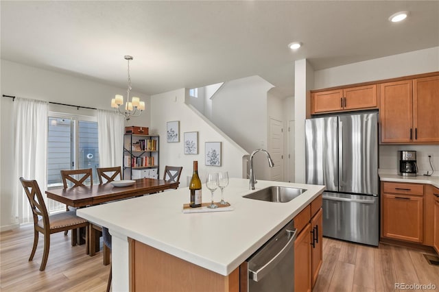 23920 E 34th Ave, Aurora, CO 80019 - kitchen featuring appliances with stainless steel finishes, a sink, light wood-style floors, light countertops, and recessed lighting