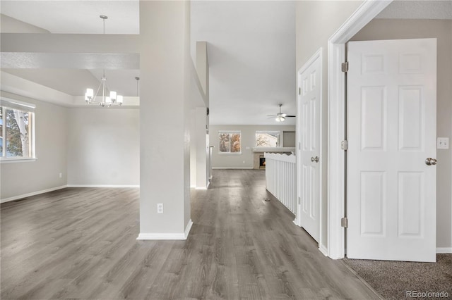 corridor featuring hardwood / wood-style flooring and a notable chandelier