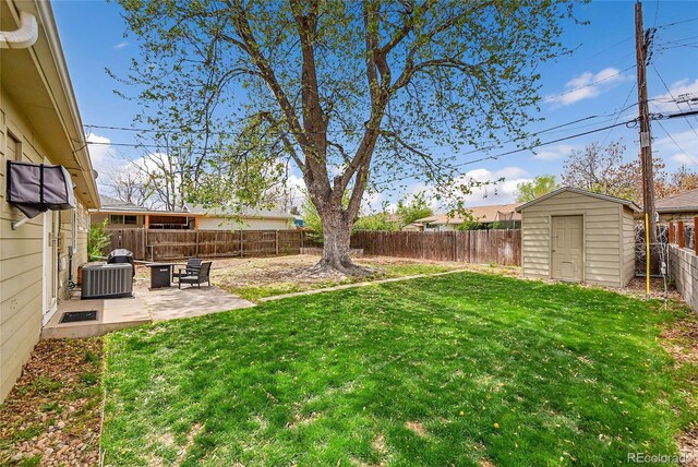 view of yard with an outdoor structure, a patio, a fenced backyard, a shed, and central AC unit
