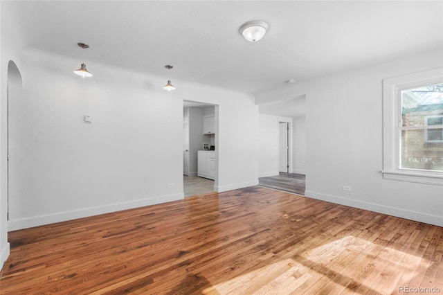 unfurnished living room featuring wood-type flooring