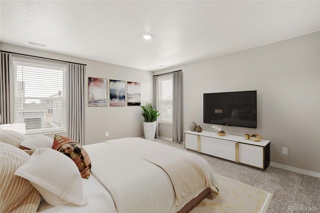 bedroom featuring carpet floors and baseboards