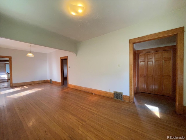 spare room with wood-type flooring