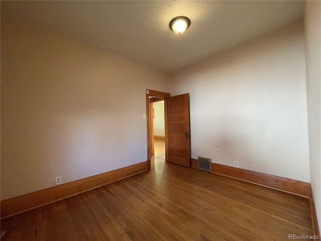 spare room featuring hardwood / wood-style flooring