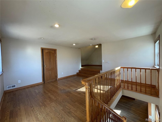 stairs featuring hardwood / wood-style floors