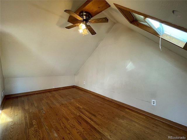 bonus room with hardwood / wood-style floors, lofted ceiling with skylight, and ceiling fan