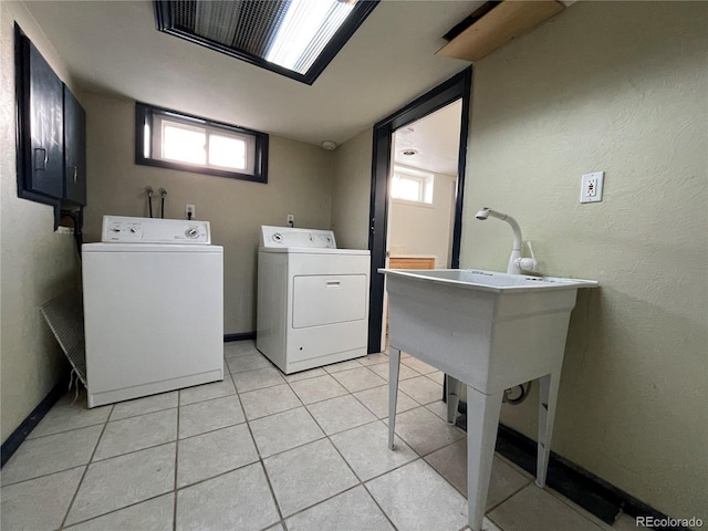 laundry room featuring washer and dryer and light tile patterned floors