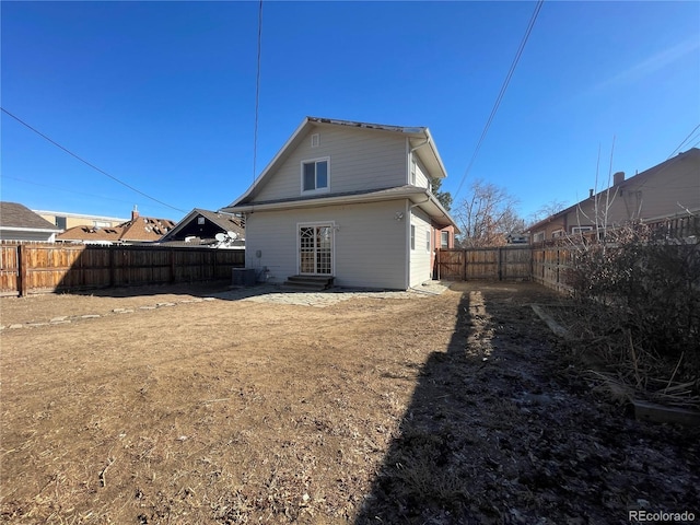 rear view of property with central AC unit