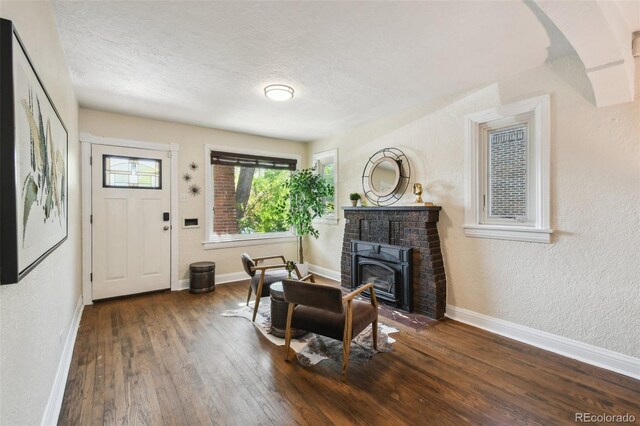 1633 Gaylord St, Denver, CO 80206 - foyer featuring wood-type flooring, baseboards, a textured ceiling, and a textured wall