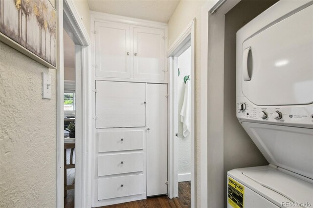 1633 Gaylord St, Denver, CO 80206 - washroom featuring estacked washer and dryer and dark wood-type flooring