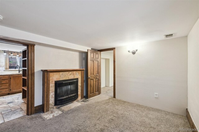 1633 Gaylord St, Denver, CO 80206 - unfurnished living room featuring light carpet, a fireplace, and a sink