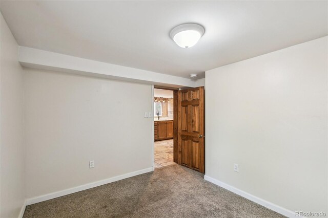 1633 Gaylord St, Denver, CO 80206 - unfurnished room with baseboards, light carpet, and a sink