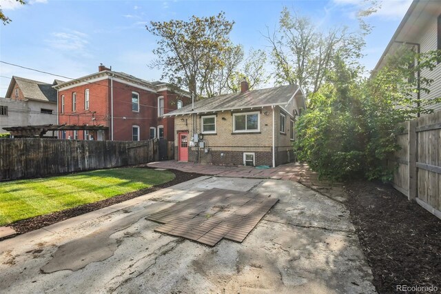 1633 Gaylord St, Denver, CO 80206 - rear view of property featuring brick siding, a patio area, and a chimney